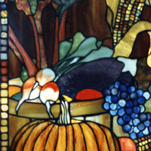 This is a photographic detail of a larger stained glass window in the Tiffany style with a traditional American harvest theme
